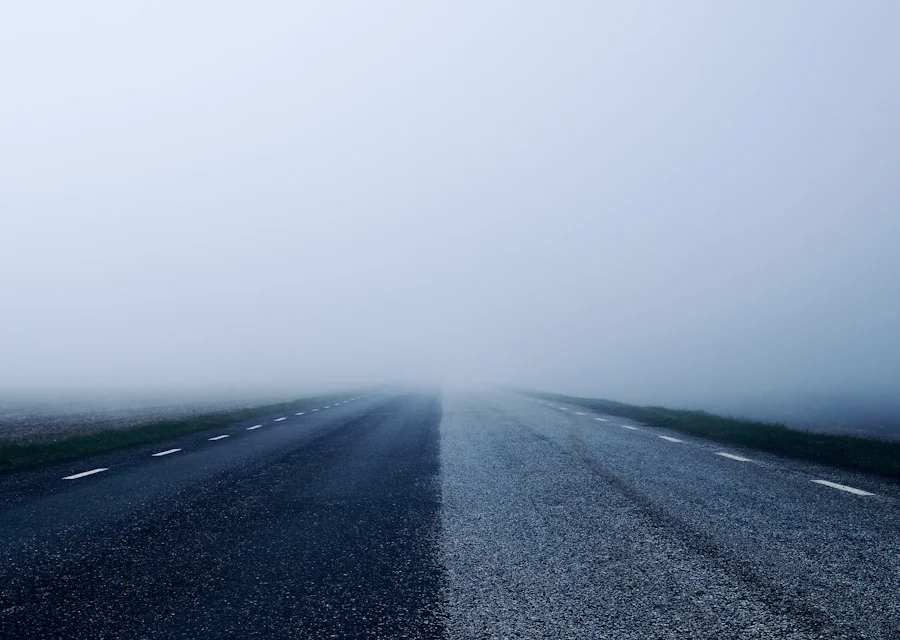 A road disappearing into thick fog