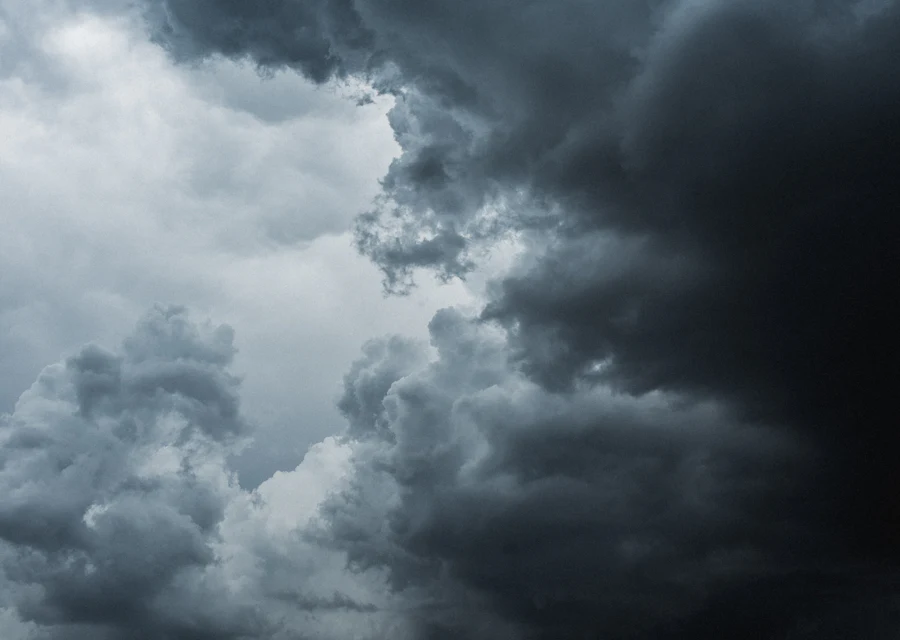 A dark storm cloud building over open ground